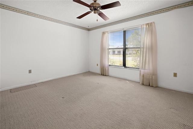 spare room with ceiling fan, a textured ceiling, ornamental molding, and light colored carpet