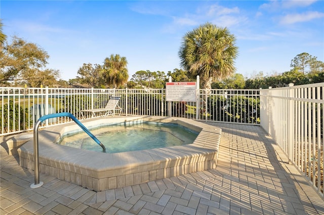 view of swimming pool featuring a community hot tub and a patio area