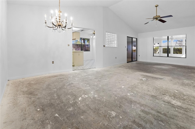 unfurnished living room featuring ceiling fan with notable chandelier and high vaulted ceiling