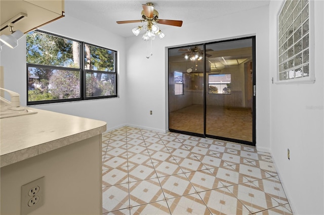 interior space featuring light tile patterned floors and ceiling fan