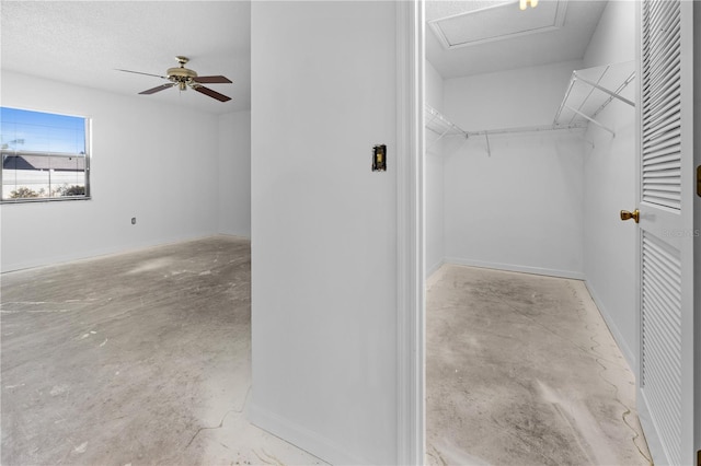 walk in closet with ceiling fan