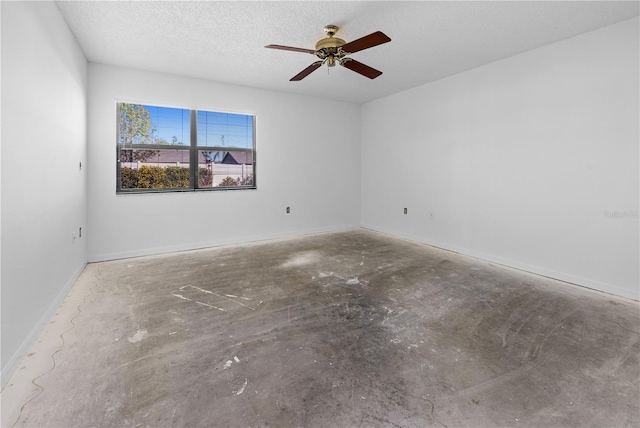 unfurnished room with concrete flooring, ceiling fan, and a textured ceiling