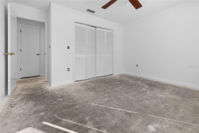 unfurnished bedroom with ceiling fan, a closet, and concrete floors