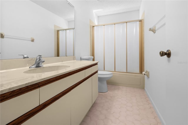 full bathroom featuring combined bath / shower with glass door, vanity, a textured ceiling, tile patterned floors, and toilet