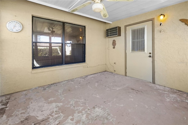 doorway to property with a wall mounted air conditioner, ceiling fan, and a patio area