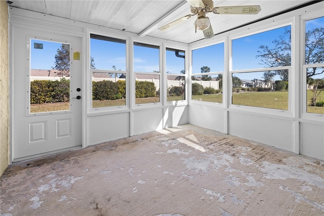 unfurnished sunroom featuring ceiling fan