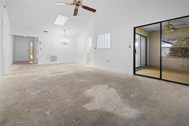 unfurnished living room featuring lofted ceiling and ceiling fan with notable chandelier