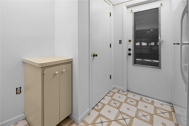 doorway to outside featuring light tile patterned flooring