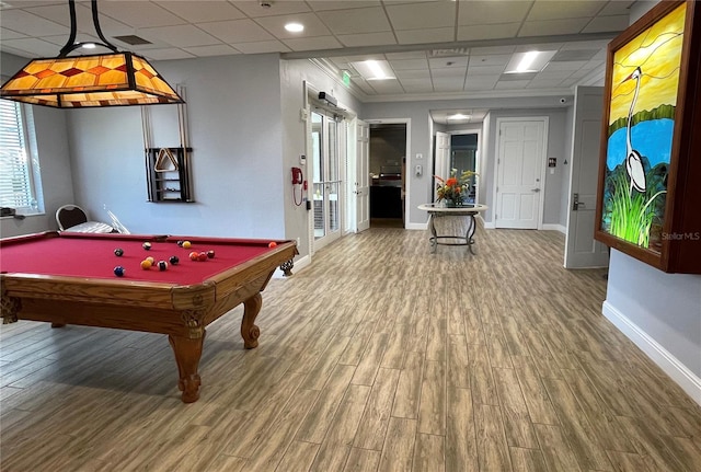 playroom featuring wood-type flooring, a healthy amount of sunlight, pool table, and a drop ceiling