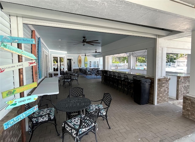 view of patio with a bar and ceiling fan