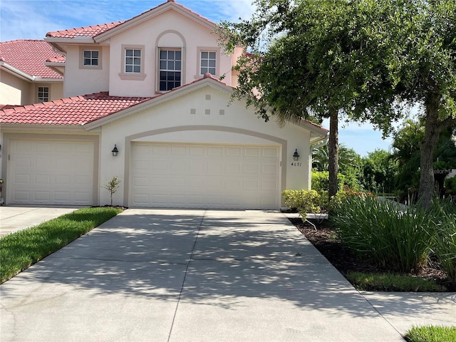 mediterranean / spanish home with a garage