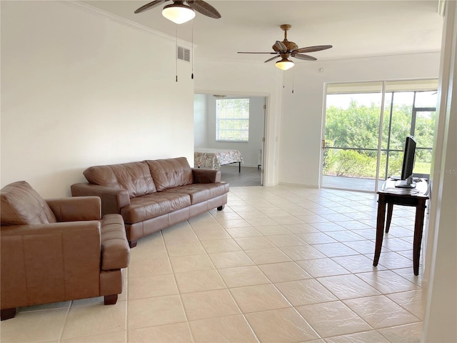 living room featuring crown molding, ceiling fan, and light tile patterned flooring