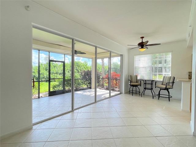 sunroom / solarium with ceiling fan