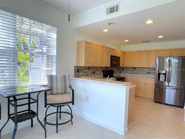 kitchen with range with electric stovetop, a breakfast bar, stainless steel fridge with ice dispenser, kitchen peninsula, and light brown cabinets