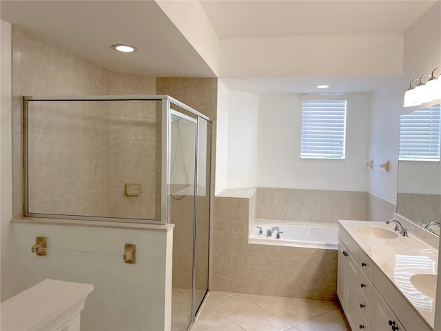 bathroom featuring tile patterned flooring, vanity, and shower with separate bathtub