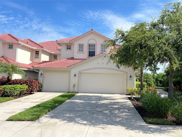 mediterranean / spanish-style home with a garage