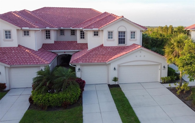 mediterranean / spanish-style home with a garage