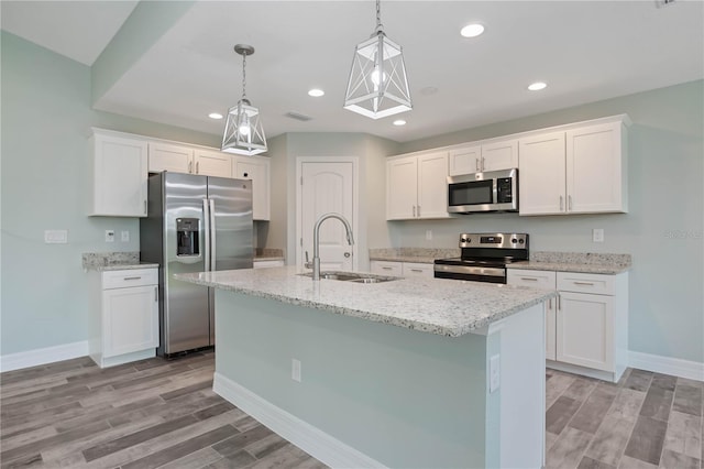 kitchen featuring white cabinetry, stainless steel appliances, light hardwood / wood-style floors, a kitchen island with sink, and sink