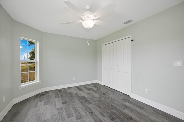 unfurnished bedroom featuring a closet, ceiling fan, and dark hardwood / wood-style floors