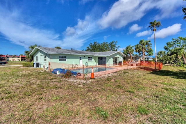 rear view of house featuring a patio and a yard