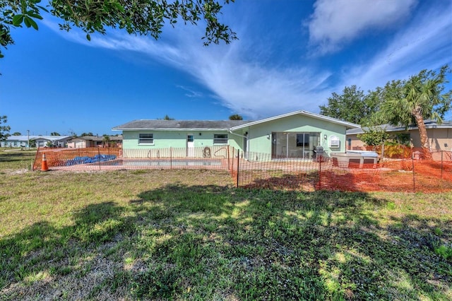 rear view of property with a yard