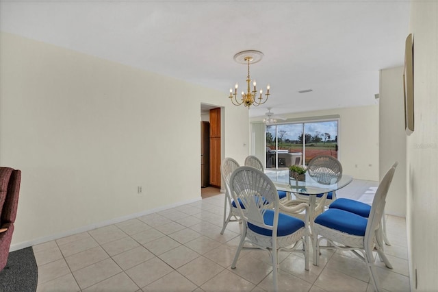 tiled dining space with ceiling fan with notable chandelier