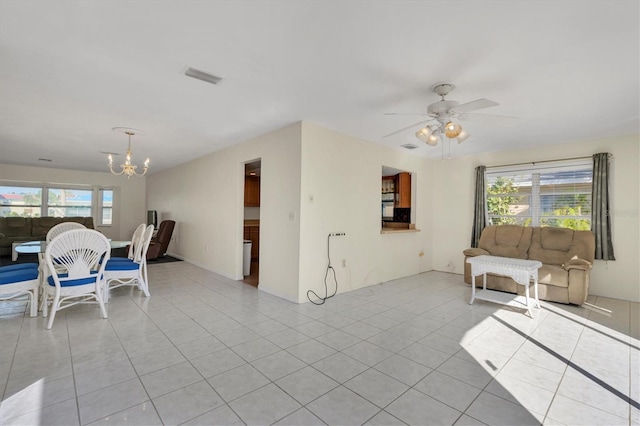 interior space with ceiling fan with notable chandelier