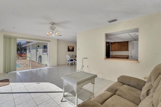 tiled living room with ceiling fan