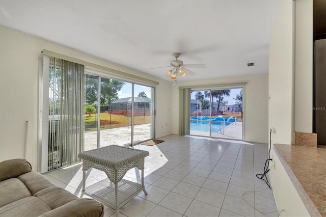 living room with ceiling fan and light tile flooring