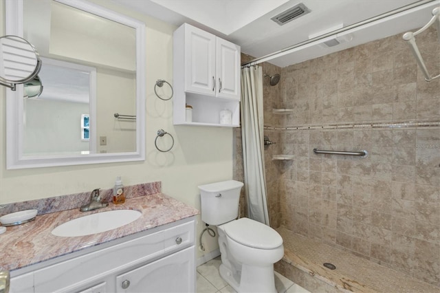 bathroom with tile flooring, walk in shower, vanity, and toilet