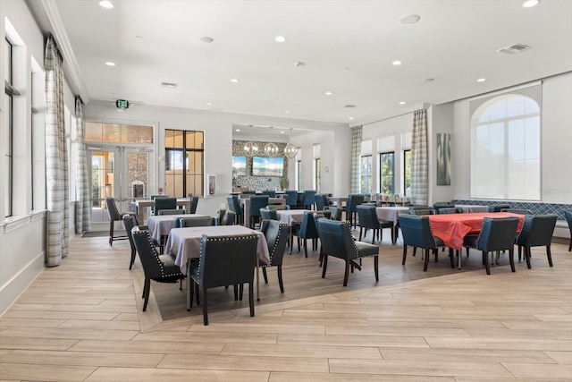 dining area featuring french doors and crown molding