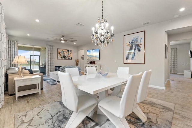 dining area with ceiling fan with notable chandelier