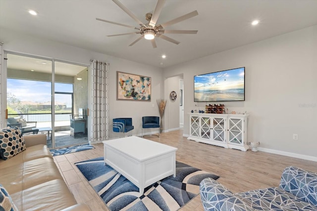 living room featuring ceiling fan and light hardwood / wood-style flooring