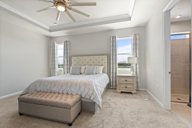 carpeted bedroom featuring ceiling fan, a raised ceiling, and ornamental molding