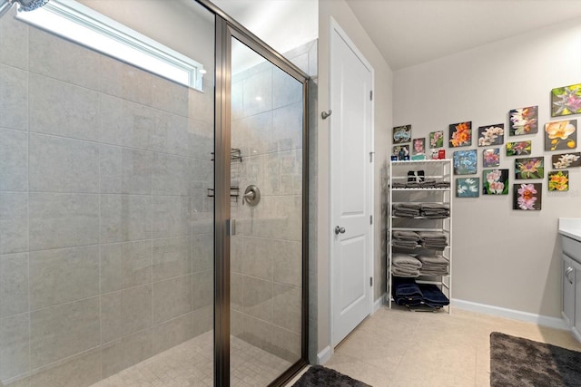 bathroom with tile patterned flooring, vanity, and an enclosed shower