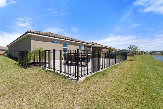 exterior space with a water view and a lawn