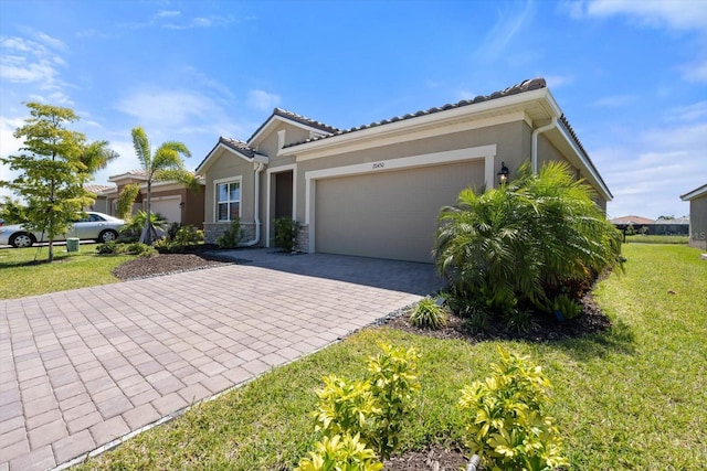 view of front of house with a front yard and a garage