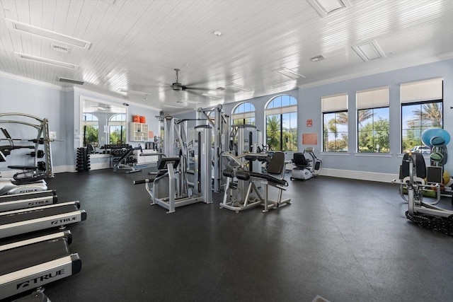 gym featuring ceiling fan and ornamental molding