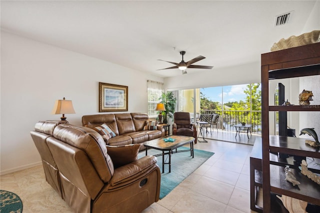 tiled living room with ceiling fan