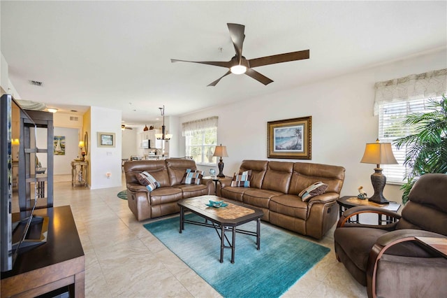 tiled living room featuring ceiling fan