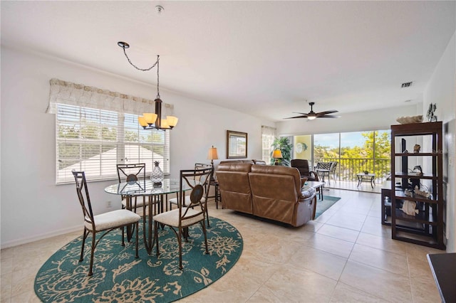 dining space featuring plenty of natural light, ceiling fan with notable chandelier, and light tile floors