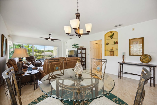 tiled dining area featuring ceiling fan with notable chandelier