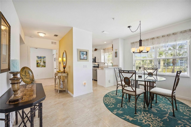 dining space featuring an inviting chandelier and light tile flooring