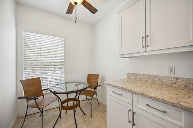 tiled dining space with ceiling fan