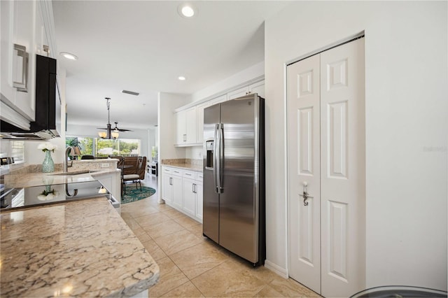 kitchen with stainless steel fridge with ice dispenser, white cabinets, pendant lighting, and light stone countertops