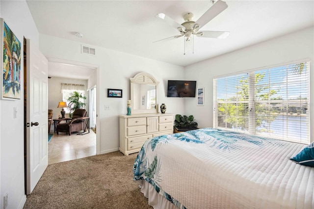 bedroom featuring light colored carpet and ceiling fan