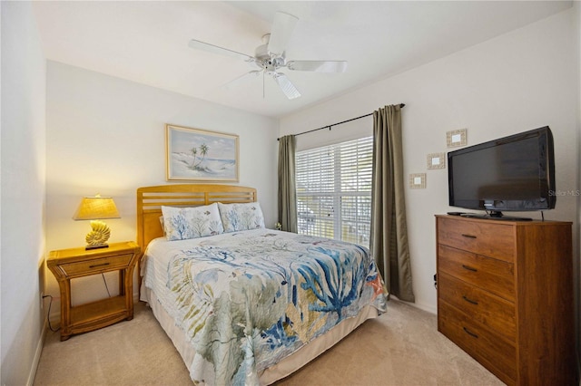 bedroom featuring light carpet and ceiling fan