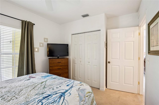 carpeted bedroom with a closet and ceiling fan