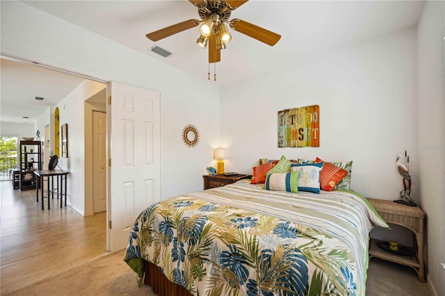 bedroom with ceiling fan and light tile floors