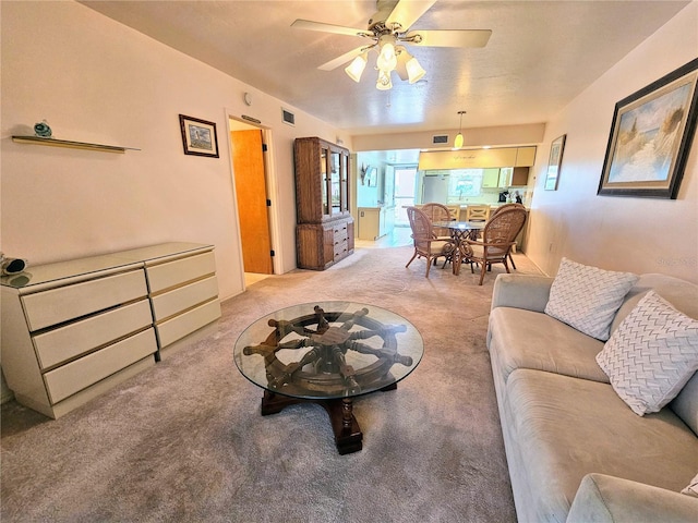 living room featuring light carpet and ceiling fan